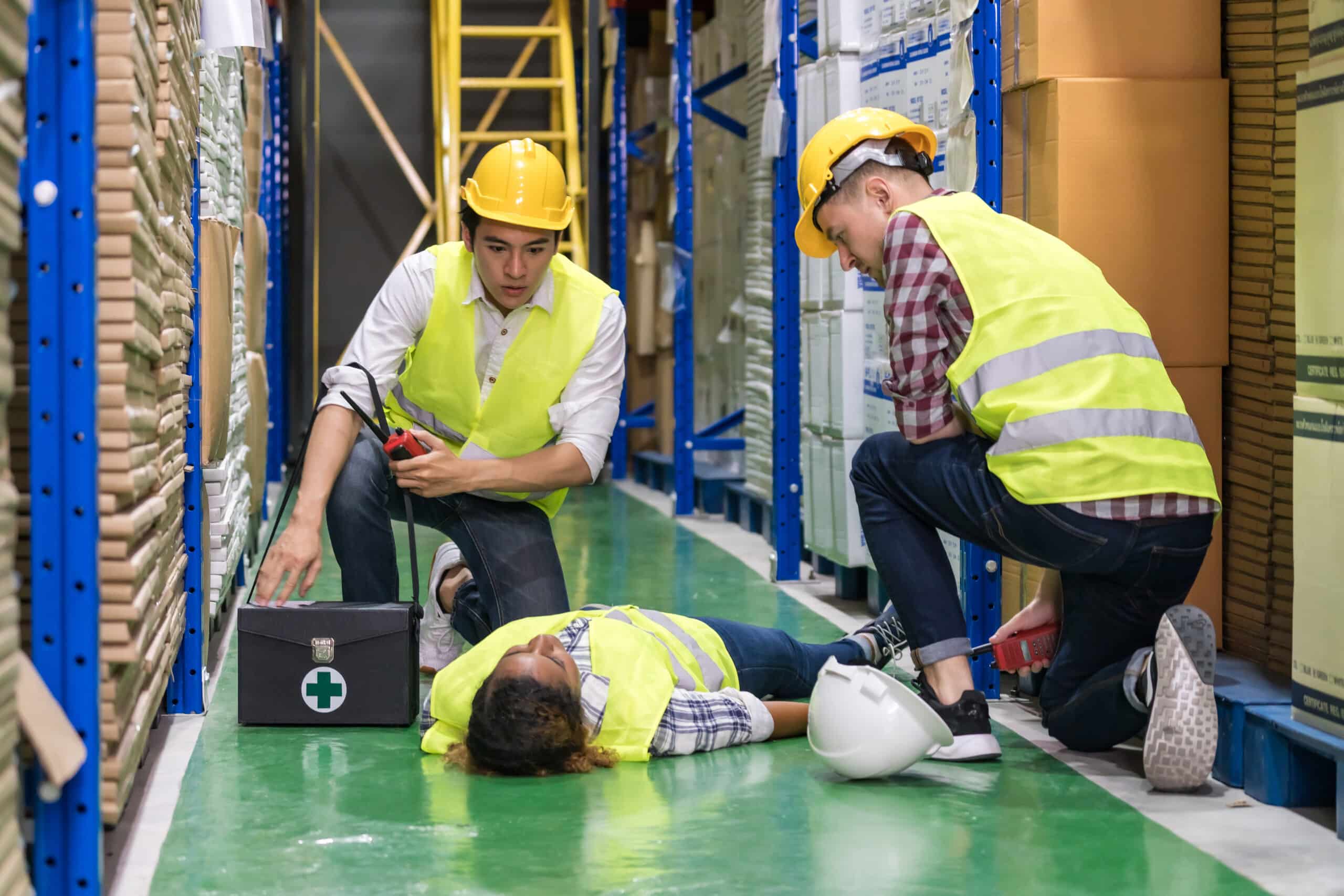Warehouse worker first aid after accident.