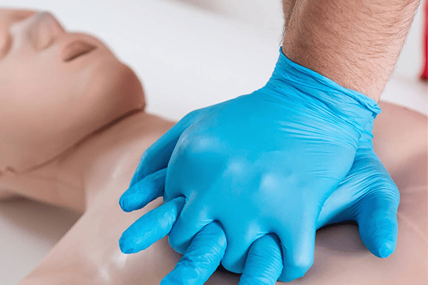 student learning basic cpr wear blue gloves